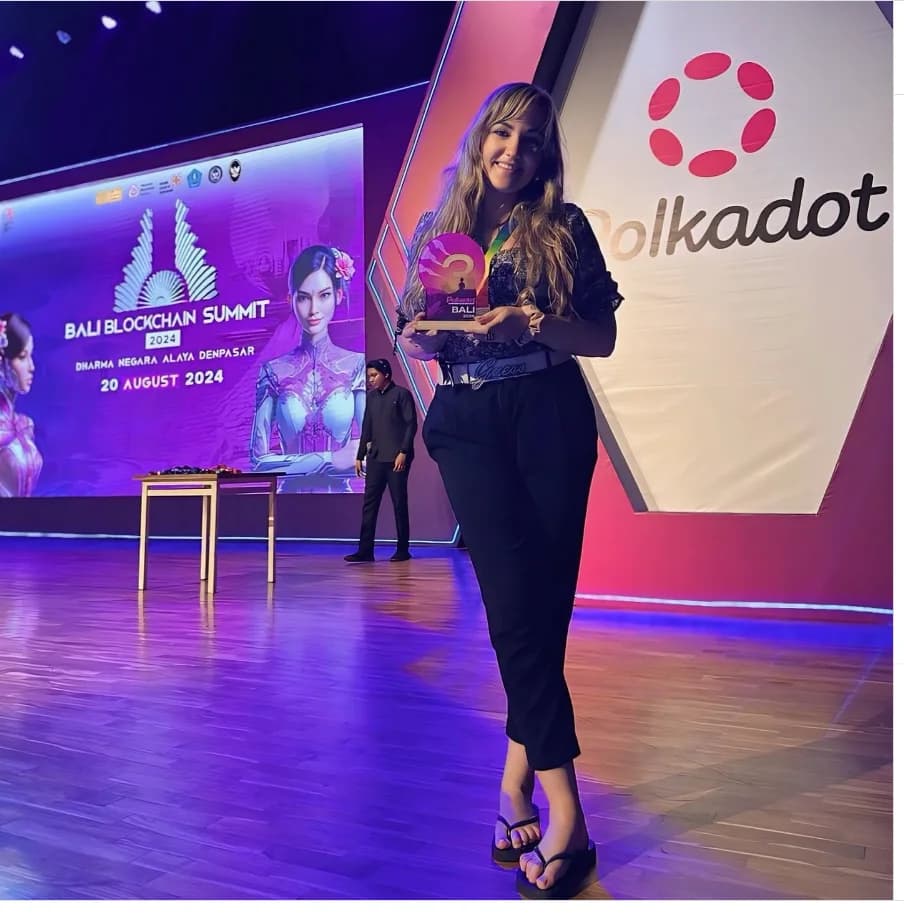 Silvia Mogas on stage at Bali Blockchain Summit 2024 with Polkadot branding